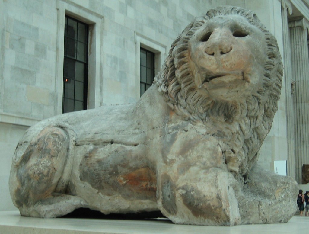 A massive, weathered marble lion. 