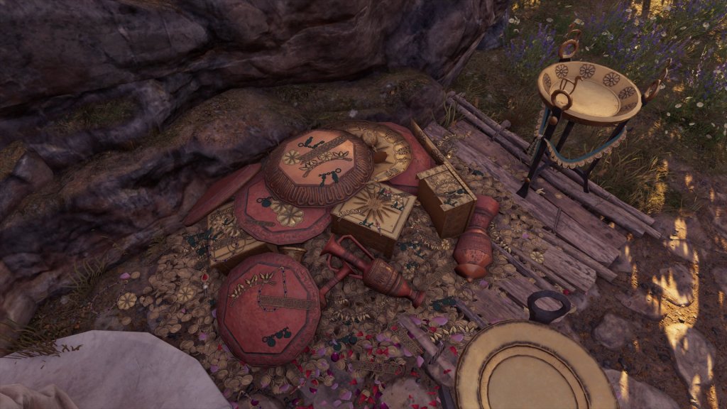 A pile of gold coins, tripods, clay dishes, and copies of the Vergina gold larnax. 