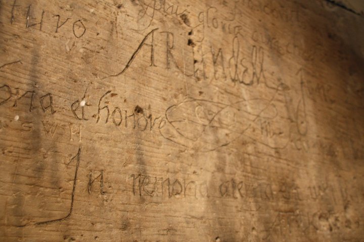 Various names carved into a wall. 